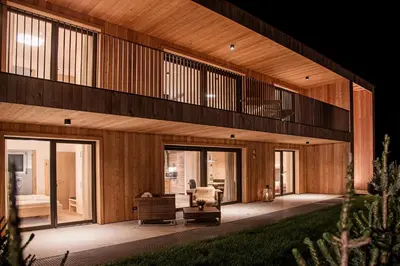 an exterior view of a house with wooden walls at Alpine Chalets App. Pichlerhof in Brunico