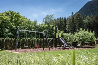 a playground with a slide in a park at Appartements Bäckhof in Villa Ottone