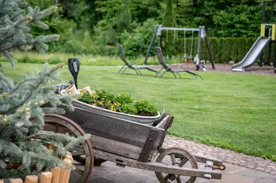 a wooden cart filled with plants in a park at Appartements Bäckhof in Villa Ottone