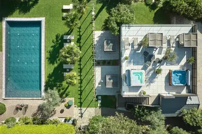 an overhead view of a house with a swimming pool at Das Panorama Designhotel in Caldaro