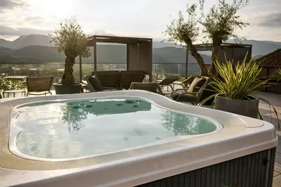 a hot tub on the roof of a resort at Das Panorama Designhotel in Caldaro