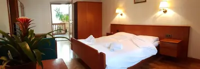 a bedroom with a bed with two books on it at Weißes Rössl in Appiano sulla Strada del Vino
