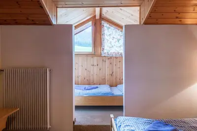 a small room with a bed and a window at Appartements Pension Sonia in Funes