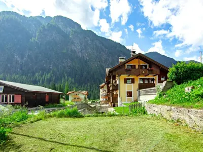 a large building with cars parked in front of it at Apartment Cesa Soraruf by Interhome in Campitello di Fassa
