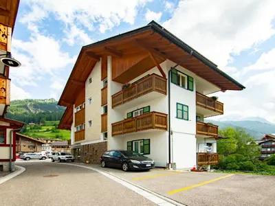 a house on a hill with mountains in the background at Apartment Cesa Soraruf by Interhome in Campitello di Fassa