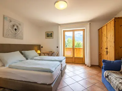 a bedroom with a large bed in a room at Apartment Cesa Soraruf by Interhome in Campitello di Fassa