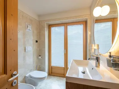 a bathroom with a toilet and a sink at Apartment Cesa Soraruf by Interhome in Campitello di Fassa
