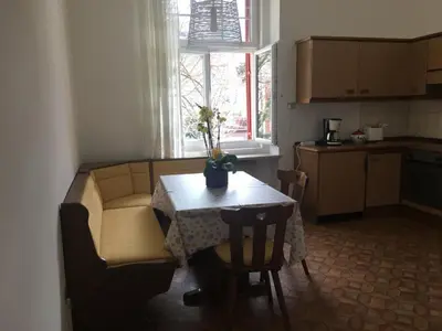 a kitchen with a table and a couch and a table at Appartamento Nadia in Merano