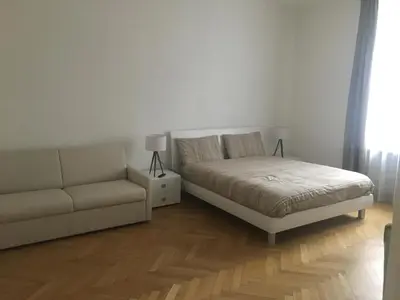 a bedroom with a bed and a couch at Appartamento Nadia in Merano