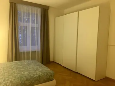 a bedroom with a bed and a large cabinet at Appartamento Nadia in Merano