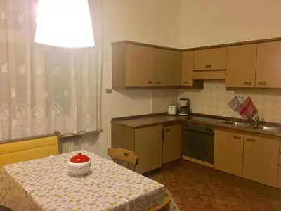 a small kitchen with a table with a bowl on it at Appartamento Nadia in Merano