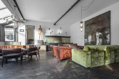 a living room with couches and a bar at Artefugium Atelier in Selva di Val Gardena