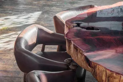 a wooden table and chairs next to a wooden table at Artefugium Atelier in Selva di Val Gardena