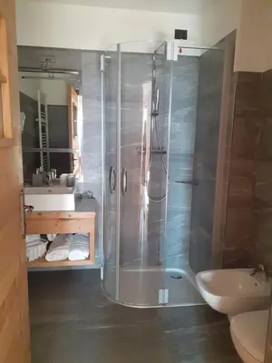 a bathroom with a shower and a sink at Agriroom in Rumo