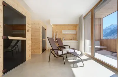 a room with chairs and a kitchen with a view at Living Nature Appartements in San Vigilio Di Marebbe