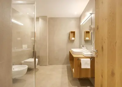 a bathroom with a sink and a toilet and a shower at Living Nature Appartements in San Vigilio Di Marebbe