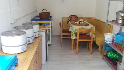 a kitchen with a table and chairs and a table with at Albergo Antico in Predazzo