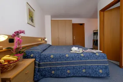 a hotel room with a bed and a basket of fruit at Albergo Antico in Predazzo