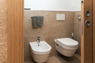 a bathroom with a toilet and a sink at Lüch Da Pćëi in San Cassiano