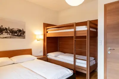 two bunk beds in a small room with a ladder at St. Ulrichhof in Lana