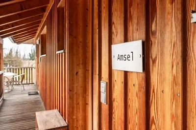 a sign on the side of a wooden building at St. Ulrichhof in Lana