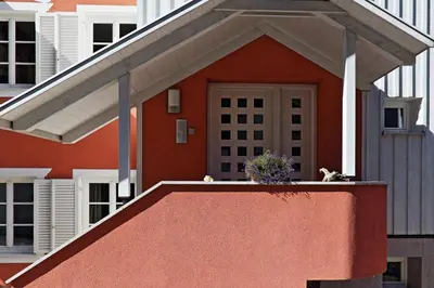 a house with two dogs sitting on a balcony at Villa Lageder in Sarntal
