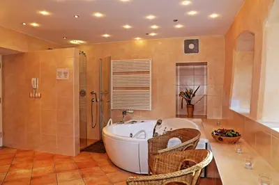 a large bathroom with a tub and a shower at Villa Lageder in Sarntal