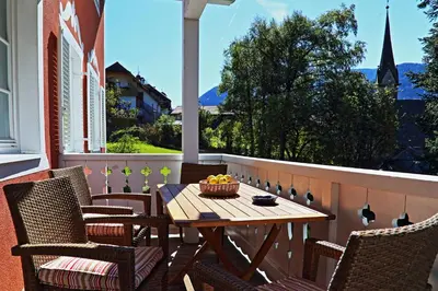 a table and chairs on a porch with a bowl of fruit at Villa Lageder in Sarntal