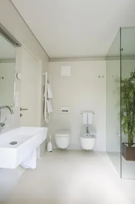 a white bathroom with a sink and a toilet at MANTANA - Apartments in San Lorenzo di Sebato
