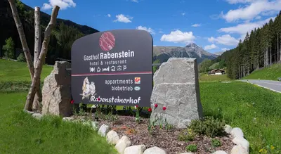 a sign on the side of a road at Gasthof Rabenstein in Sarntal