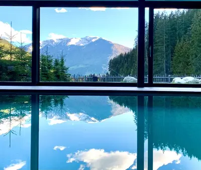 a window with a view of a lake and mountains at Gasthof Rabenstein in Sarntal