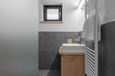 a bathroom with a sink and a mirror at Appartamenti Residence Ada in San Cassiano