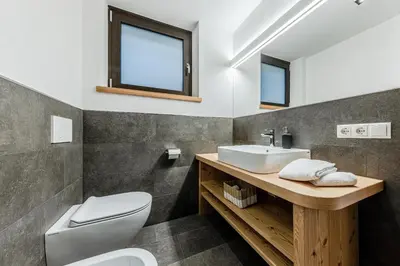 a bathroom with a sink and a toilet at Appartamenti Residence Ada in San Cassiano