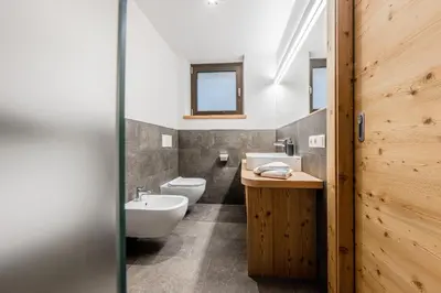 a bathroom with a sink and a toilet at Appartamenti Residence Ada in San Cassiano