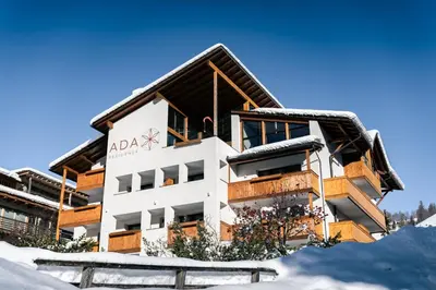 a building on top of a snow covered mountain at Appartamenti Residence Ada in San Cassiano