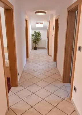 a hallway in a building with a tile floor at Villa Scherlin in Ortisei