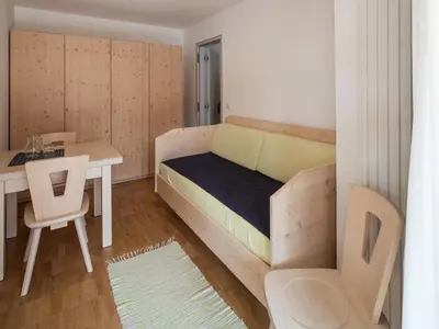 a small room with a bed and a table at Vintlerhof in Bressanone