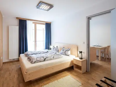 a bedroom with a bed and a window at Vintlerhof in Bressanone
