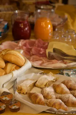 a table with a bunch of different types of food at Albergo Bellaria in Carano