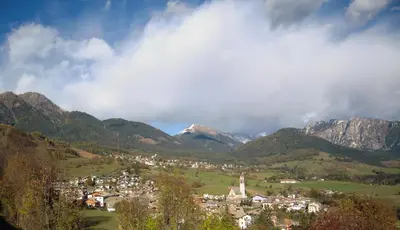 a town in the middle of a valley with mountains at Albergo Bellaria in Carano