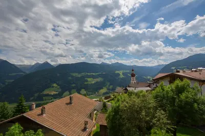 a view of a village with mountains in the background at Saxlhof in Stanghe