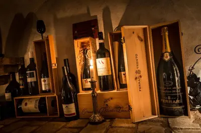 a bunch of bottles of wine in wooden boxes at Diana Dolomites in La Villa