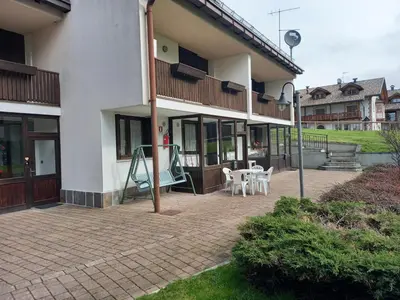 a patio of a house with a playground at Casa con vista a Moena in Moena