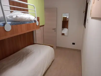 a small room with a bunk bed and a closet at Casa con vista a Moena in Moena