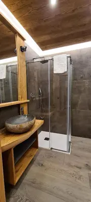 a bathroom with a shower and a sink at Appartamenti Home Service in Arabba