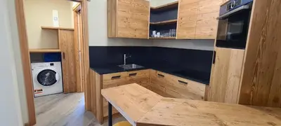 a kitchen with a sink and a washing machine at Appartamenti Home Service in Arabba