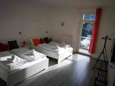 two white beds in a room with a window at Iceman Room's Central in Bolzano