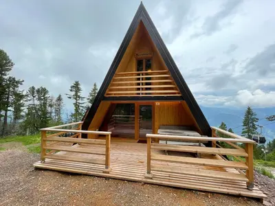 a frame cabin with a thatched roof at Chalet Biancaneve - Alpe Cermis Cavalese in Cavalese