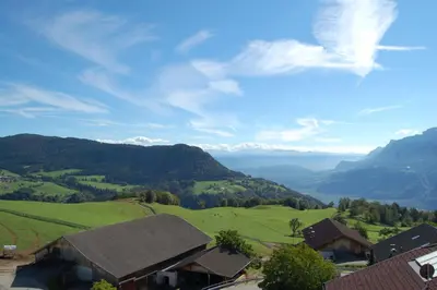a view of a valley with green hills and mountains at Pension Schlaneiderhof in Meltina