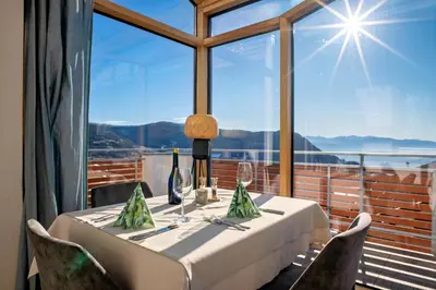 a table in a room with a large window at Pension Schlaneiderhof in Meltina